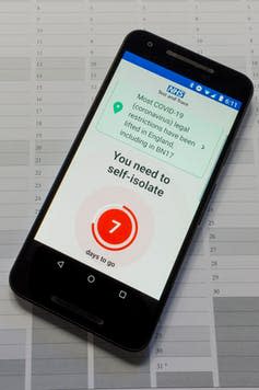 An image of the NHS test and trace app open on a mobile phone telling the user that they need to self isolate