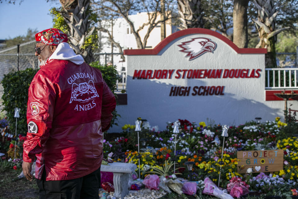 David Cobra Clemente stands guard at a memorial outside the school during the one year anniversary of the shooting death of 17 at Marjory Stoneman Douglas High School Thursday, Feb. 14, 2019 in Parkland, Fla. (Al Diaz/Miami Herald/Tribune News Service via Getty Images)