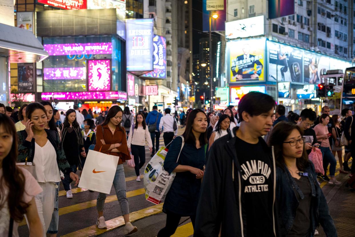 Pedestrians cross a road in the popular shopping district of Causeway Bay in Hong Kong on October 30, 2019, a day before the citys third-quarter gross domestic product (GDP) figures are released. (Photo by Anthony WALLACE / AFP) (Photo by ANTHONY WALLACE/AFP via Getty Images)