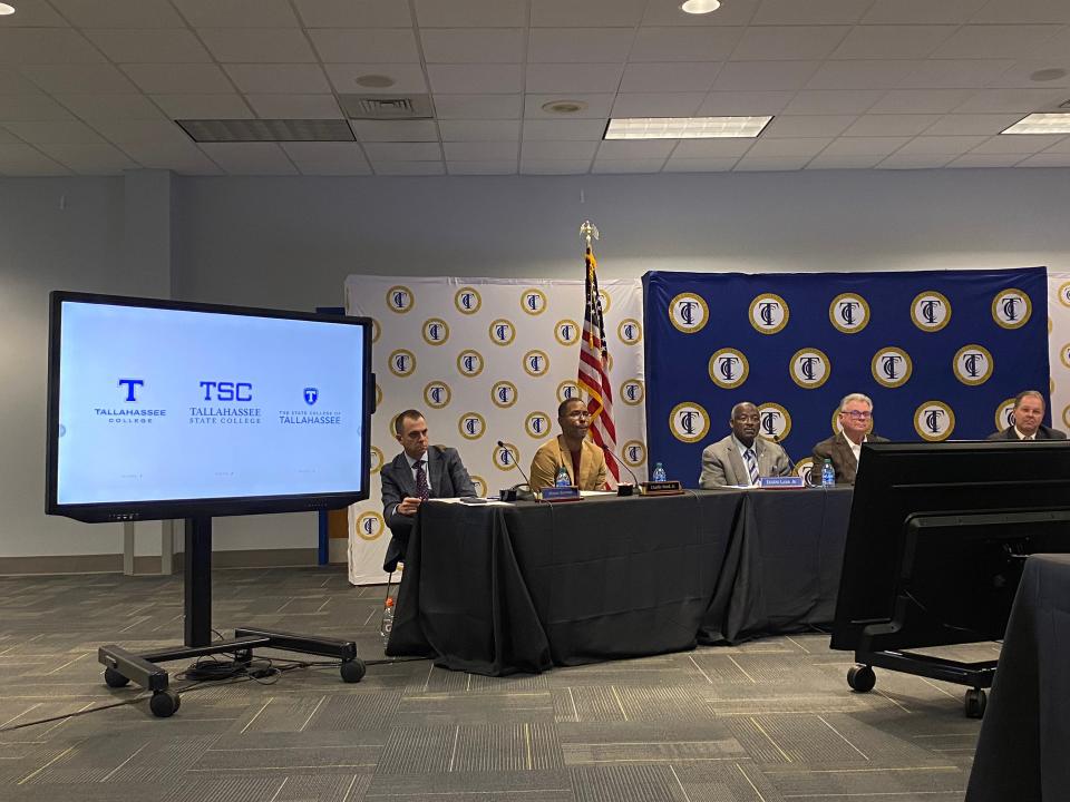 TCC trustees and President Jim Murdaugh sit alongside a screen that displays three name and logo proposals for the college's rebranding project.