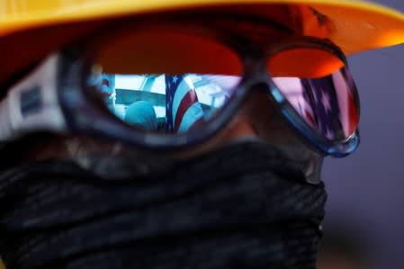 US flags are reflected in an anti-government protester's sunglasses during a rally at the University of Hong Kong