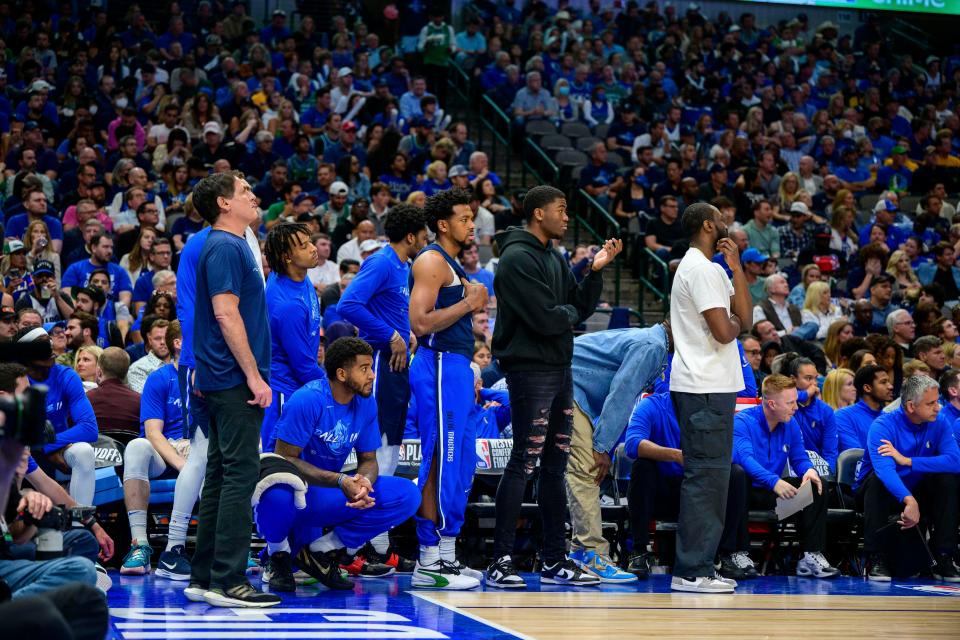 Mavericks' Theo Pinson is seen here on the bench with a white shirt on.