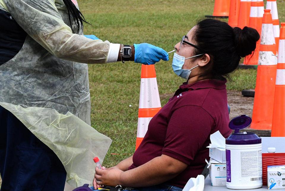 <span class="caption">A positive COVID-19 test is the first step in the process.</span> <span class="attribution"><a class="link rapid-noclick-resp" href="https://www.gettyimages.com/detail/news-photo/health-care-worker-collects-swab-sample-from-a-woman-at-a-news-photo/1237560683?adppopup=true" rel="nofollow noopener" target="_blank" data-ylk="slk:Paul Hennessy/SOPA Images/LightRocket via Getty Images">Paul Hennessy/SOPA Images/LightRocket via Getty Images</a></span>