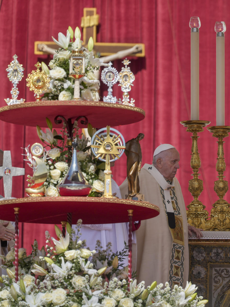 Pope Francis walks by the relics of nine new saints as he arrives on the altar in St. Peter's Square at The Vatican, Sunday, May 15, 2022, to celebrate their canonization mass. (AP Photo Gregorio Borgia)