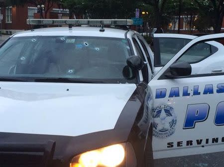 Several bullet holes are seen in the windshield of a police patrol car in Dallas, Texas, in this handout photo released by the Dallas Police Department on June 13, 2015. REUTERS/Dallas Police Department/Handout via Reuters