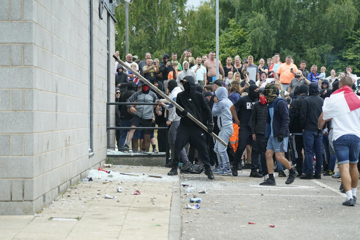 Windows are smashed as trouble flares during an anti-immigration protest outside the Holiday Inn Express in Rotherham, South Yorkshire. Picture date: Sunday August 4, 2024. (Photo by Danny Lawson/PA Images via Getty Images)