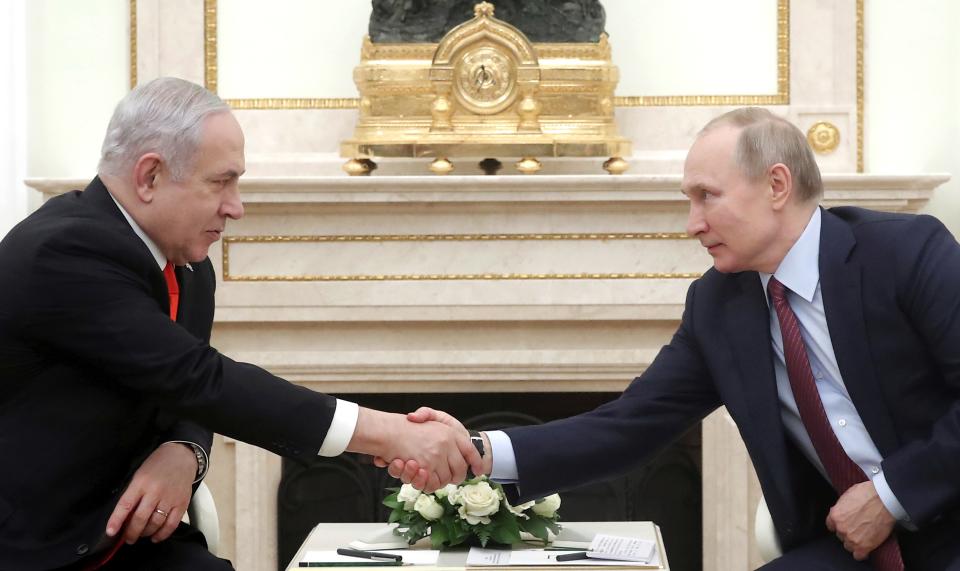 FILE - Russian President Vladimir Putin, right, shakes hands with Israeli Prime Minister Benjamin Netanyahu during their meeting in the Kremlin in Moscow, Russia, on Jan. 30, 2020. Russia and Israel have steadily expanded trade and other contacts and strengthened security ties. (Maxim Shemetov/Pool Photo via AP, File)