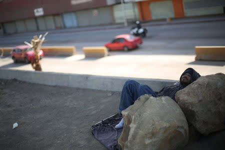 A Mexican who was recently deported from the U.S. rests near the Tijuana river, in Tijuana, Mexico, February 22, 2017. REUTERS/Edgard Garrido