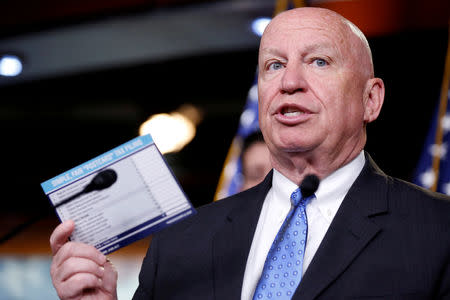 FILE PHOTO: Chairman of the House Ways and Means Committee Kevin Brady (R-TX) holds up a sample tax form as he speaks during a media briefing after the House Republican conference on Capitol Hill in Washington, U.S., April 17, 2018. REUTERS/Joshua Roberts -/File Photo