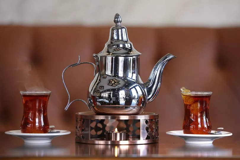 Persian tea, featuring loose black tea brewed with cardamom and cinnamon sticks