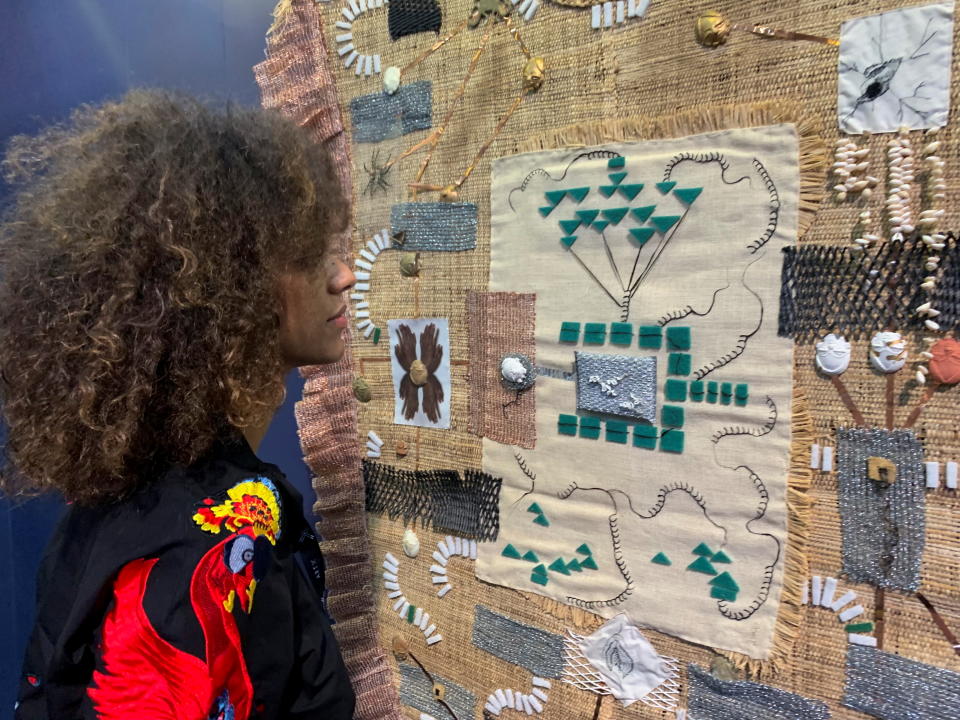 Exhibitor Cecile Fakhoury looks at an art piece displayed at the ART X fair in Lagos, Nigeria November 5, 2021. Picture taken November 5, 2021. REUTERS/Nneka Chile