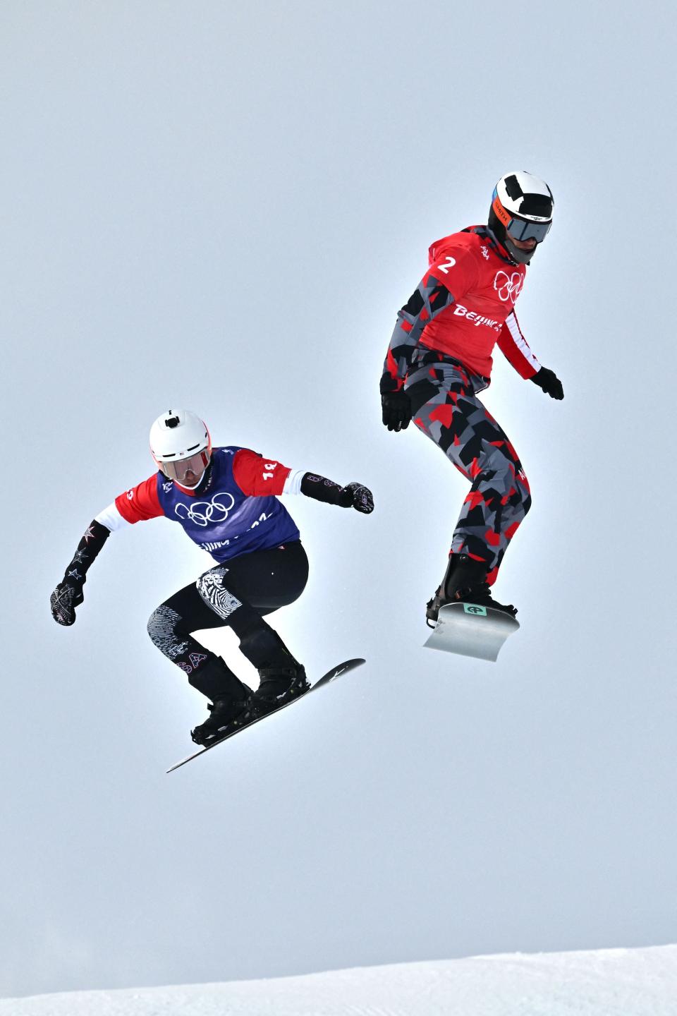 Pinckney's Jake Vedder (left) finished sixth in the 2022 Winter Olympic Games in the individual snowboard cross race.