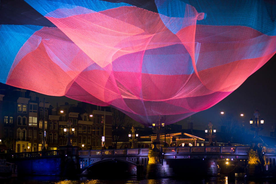 U.S. artist Janet Echelman's artwork 1.26 Amsterdam spans Amstel river during the opening of the Amsterdam Light Festival . The artwork refers to the earthquake in Chili of February 2010 that reduced the day by 1.26 microsecondsNetherlands Amsterdam Light Festival, Amsterdam, Netherlands