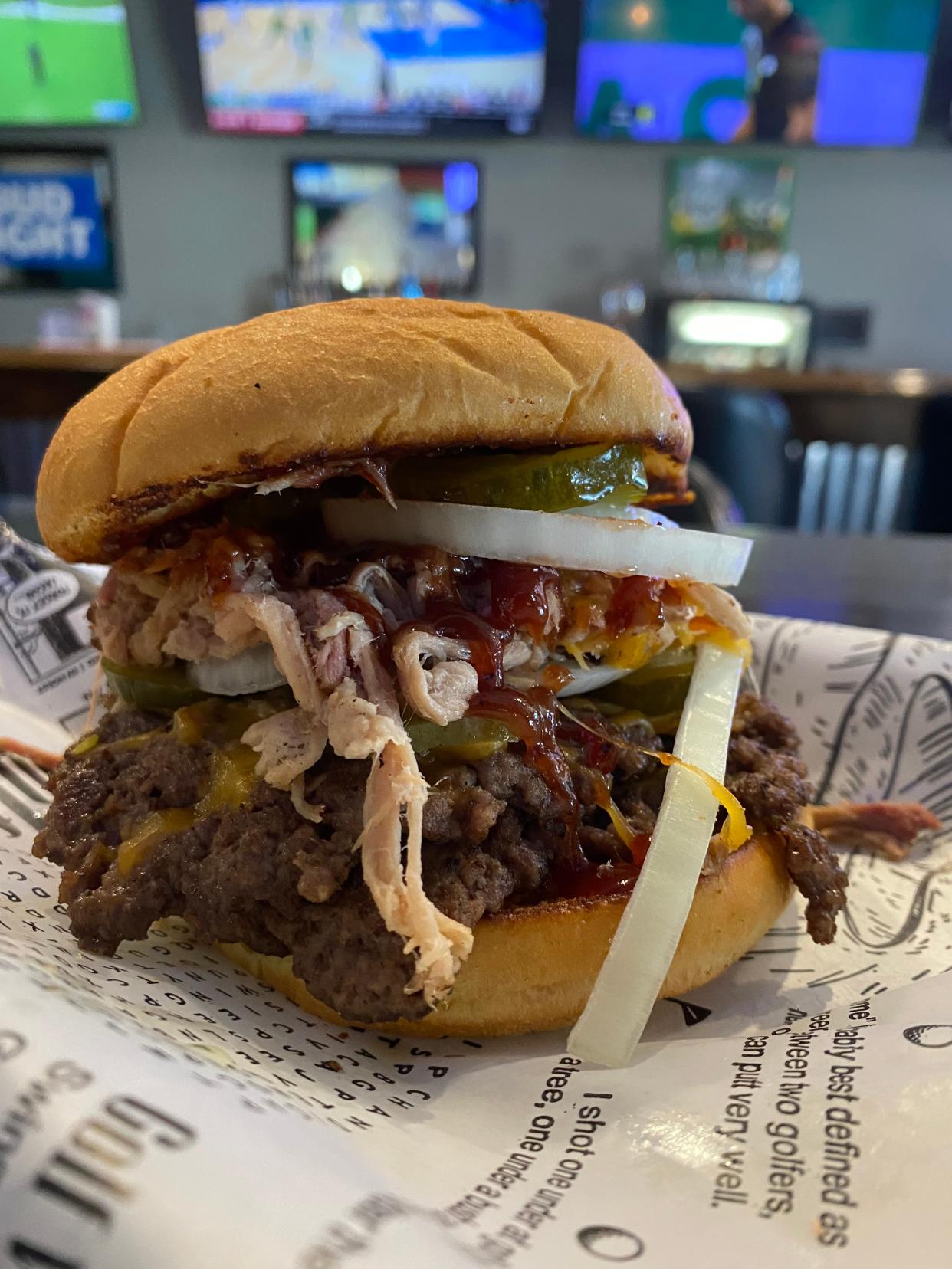 A barbecue burger with pulled pork, pickles, onions and a drizzle of barbecue sauce from Neighbors in Newburgh.