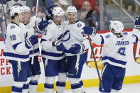 Tampa Bay Lightning's Mikhail Sergachev (98), Ondrej Palat (18), Anthony Cirelli (71), Kevin Shattenkirk (22) and Tyler Johnson (9) celebrate Cirelli's hat-trick goal against the Winnipeg Jets during third-period NHL hockey game action in Winnipeg, Manitoba, Friday, Jan. 17, 2020. (John Woods/The Canadian Press via AP)