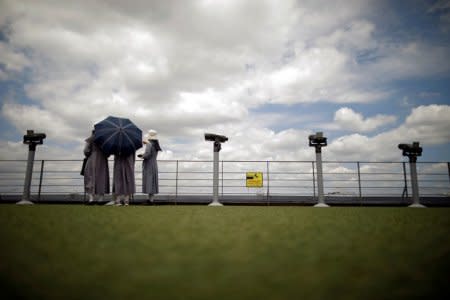 FILE PHOTO - Nuns look toward the north standing between binoculars near the demilitarized zone in Paju, South Korea, June 12, 2018.   REUTERS/Kim Hong-Ji