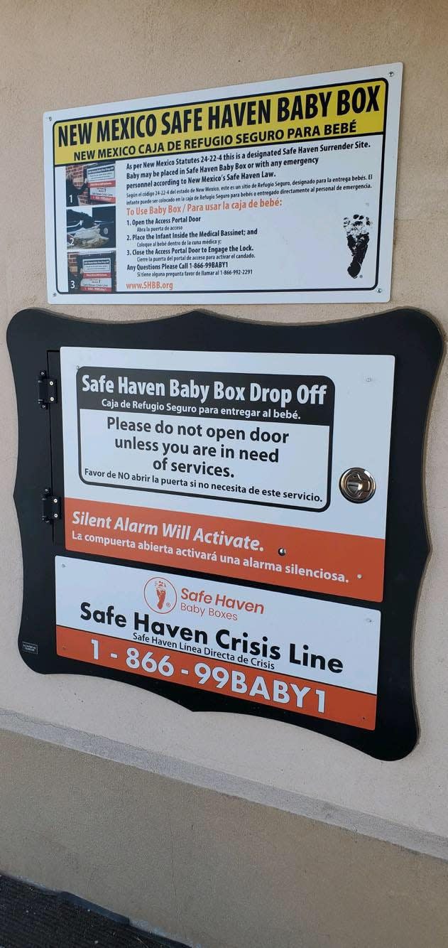 Instructions outside the City of Espanola Fire Department for a safe haven baby box inside the fire station.