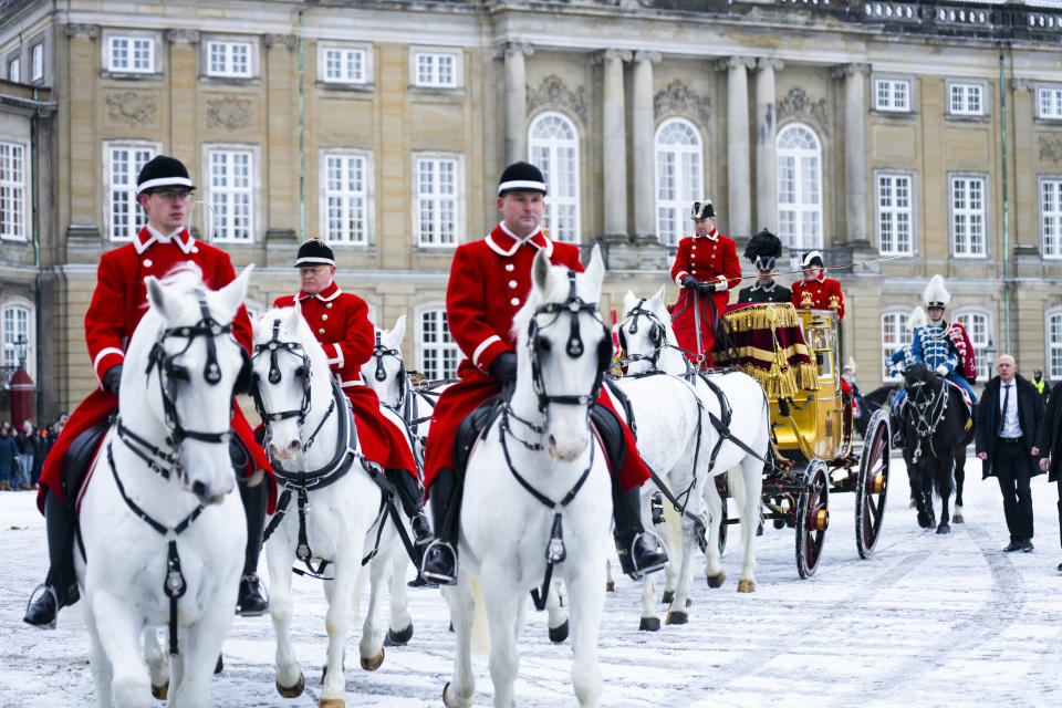 The Hussar Regiment escorts Denmark's Queen Margrethe as she rides in a horse-drawn coach from Christian IX's Palace, Amalienborg to Christiansborg Palace in Copenhagen, Denmark, Thursday Jan. 4, 2024. Europe's longest reigning monarch Queen Margrethe rode through Denmark’s capital Thursday in a gilded, horse-drawn coach as she concluded her last New Year celebrations before her abdication later this month. (Emil Nicolai Helms/Ritzau Scanpix via AP)