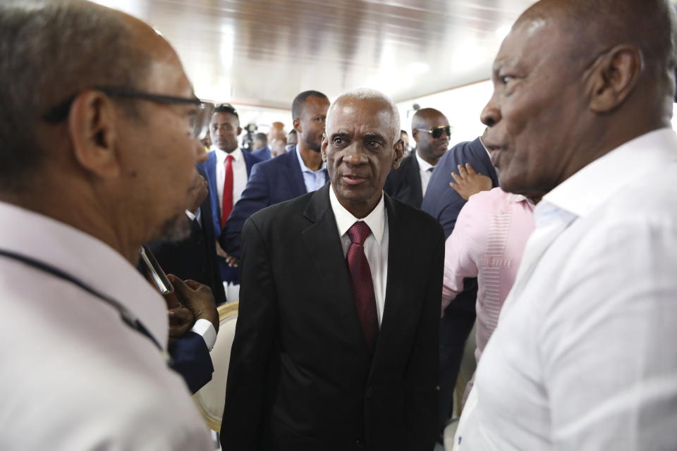 Edgard Leblanc Fils speaks to others after the transitional council named him president in Port-au-Prince, Haiti, Tuesday, April 30, 2024. The transitional council will act as the country’s presidency until it can arrange presidential elections sometime before it disbands, which must be by February 2026. (AP Photo/Odelyn Joseph)