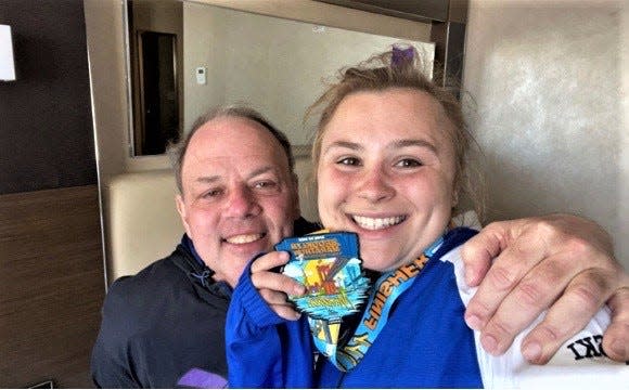 Walter Ostrowski with his daughter, Rachel, and her medal after she ran and completed the Brooklyn Marathon in his honor Sunday, April 24, 2022
