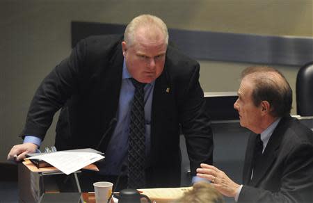 Toronto Mayor Rob Ford (L) speaks with Deputy Mayor Norm Kelly during a city council meeting in Toronto November 15, 2013. REUTERS/Jon Blacker