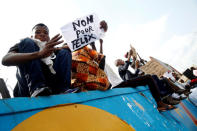 Supporters of the runner-up in Democratic Republic of Congo's presidential election, Martin Fayulu hold a sign before a political rally in Kinshasa, Democratic Republic of Congo, January 11, 2019. REUTERS/Baz Ratner