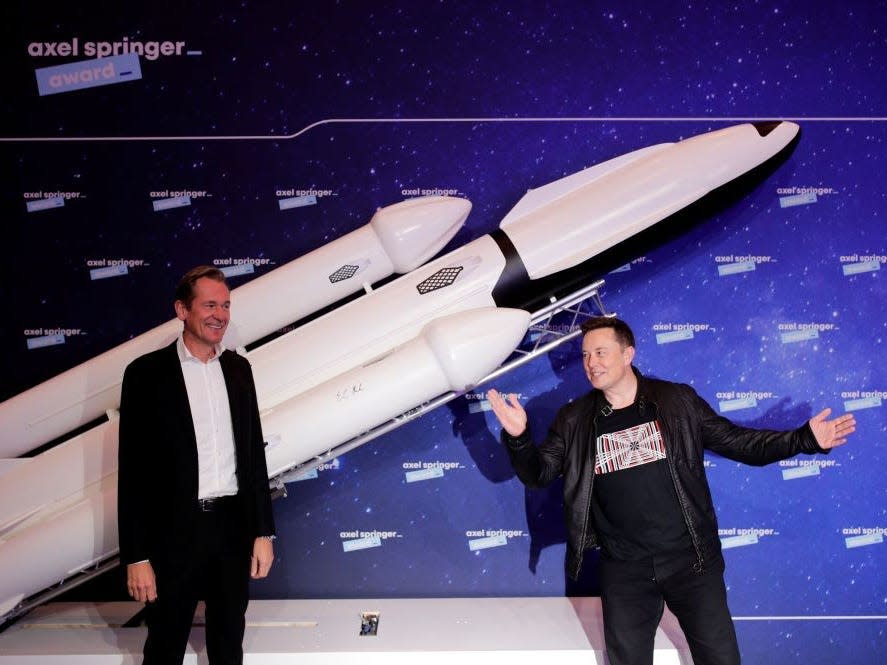 SpaceX owner and Tesla CEO Elon Musk (R) gestures as he arrives on the red carpet next to Axel Springer CEO Mathias Doepfner for the Axel Springer Awards ceremony, in Berlin, on December 1, 2020.