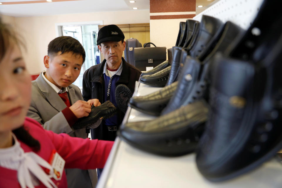 People check shoes in a shop in a newly constructed residential complex after its opening ceremony in Pyongyang, April 13, 2017.