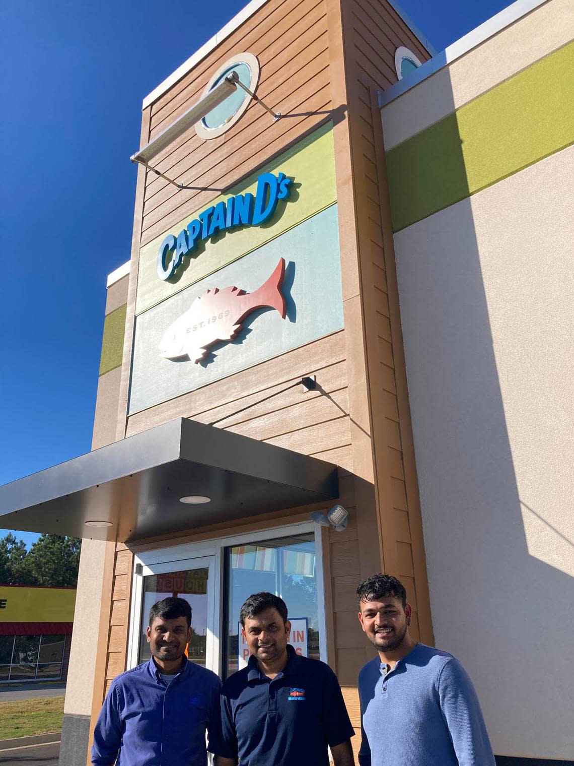 From left, franchise owner Visvesh “Victor” Patel, general manager Harsh Patel and assistant general manager Parth Patel outside the new Capt. D’s at 3004 Russell Parkway that opened Monday.
