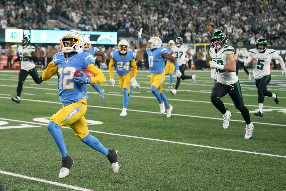 Los Angeles Chargers wide receiver Derius Davis (12) runs back a punt return for a touchdown against the New York Jets during the first quarter of an NFL football game, Monday, Nov. 6, 2023, in East Rutherford, N.J. (AP Photo/Seth Wenig)