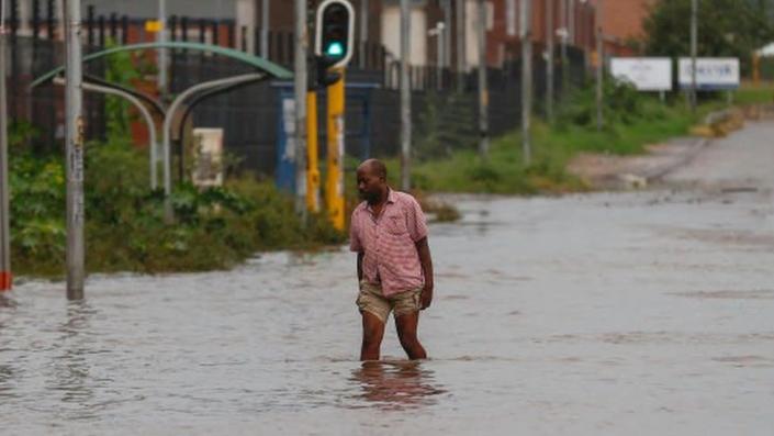 Man walking through a flooded road