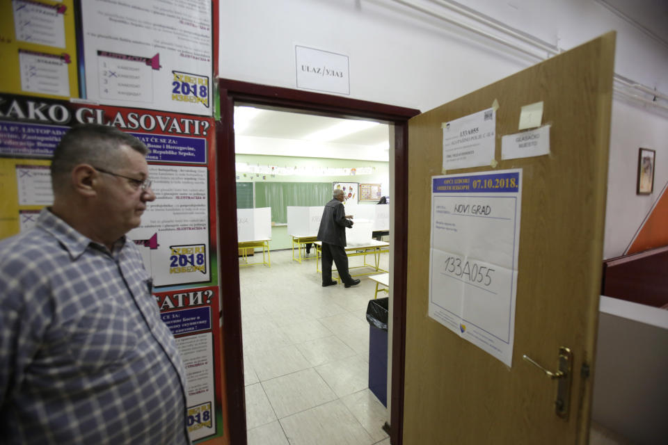 A Bosnian man casts his vote at poling station in Sarajevo, Bosnia, on Sunday, Oct. 7, 2018. Bosnia is voting Sunday in a general election that could install a pro-Russian nationalist to a top post and cement ethnic divisions drawn in a brutal war more than 20 years ago. The ballot is seen as a test of whether Bosnia will move toward integration in the European Union and NATO or remain entrenched in rivalries stemming from the 1992-95 conflict. (AP Photo/Amel Emric)