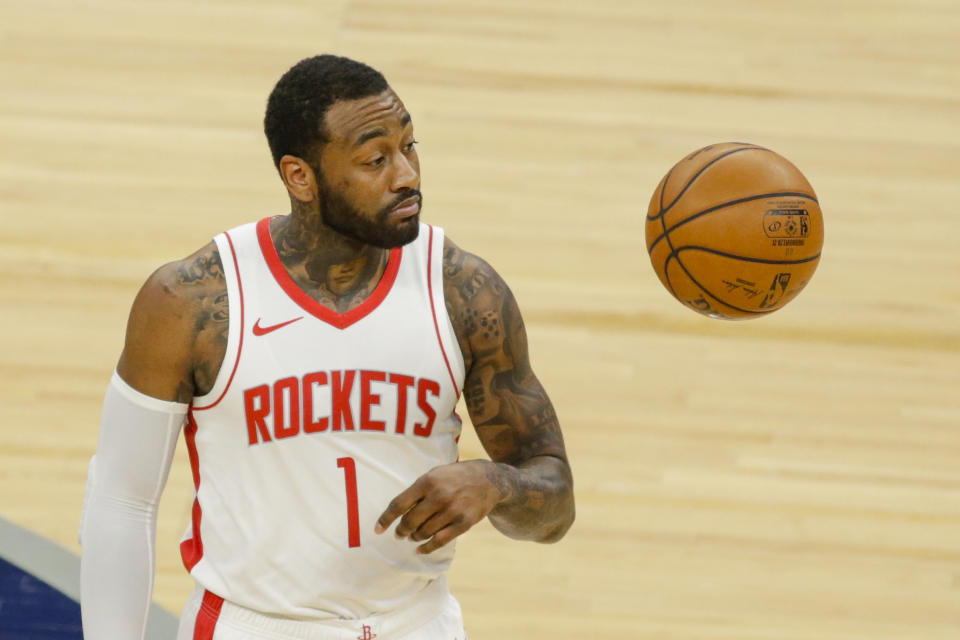 Houston Rockets guard John Wall (1) tosses the ball before an NBA basketball game against the Minnesota Timberwolves, Friday, March 26, 2021, in Minneapolis. (AP Photo/Andy Clayton-King)