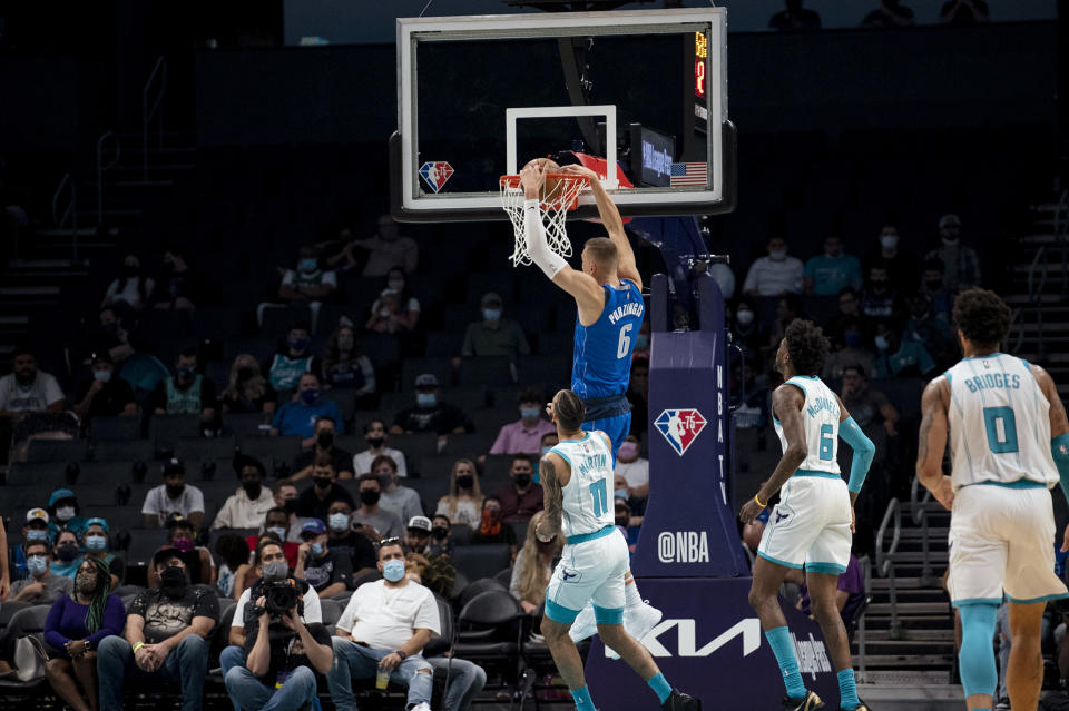 Dallas Mavericks center Kristaps Porzingis (6) dunks during the first half of the team's NBA preseason basketball game against the Charlotte Hornets, Wednesday, Oct. 13, 2021, in Charlotte, N.C. (AP Photo/Matt Kelley)