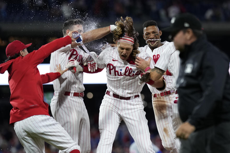 Philadelphia Phillies' Alec Bohm celebrates with teammates after hitting the game-winning run-scoring single against New York Mets pitcher Adam Ottavino during the 10th inning of a baseball game, Friday, Sept. 22, 2023, in Philadelphia. (AP Photo/Matt Slocum)