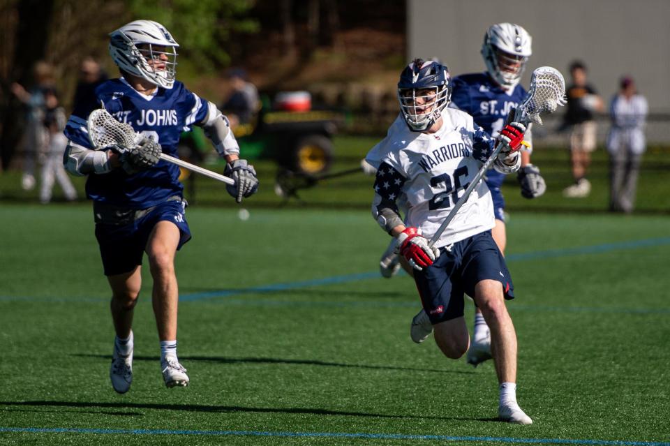 Lincoln-Sudbury junior Charlie Barringer races the ball up the field during the game in Sudbury against St. John’s Prep, May 7, 2024. The Eagles defeated the Warriors, 10-6.