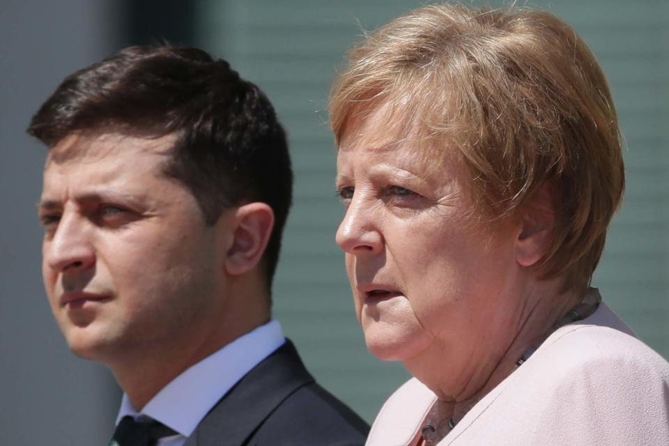 The German chancellor shook as she was stood in the sun (AP)