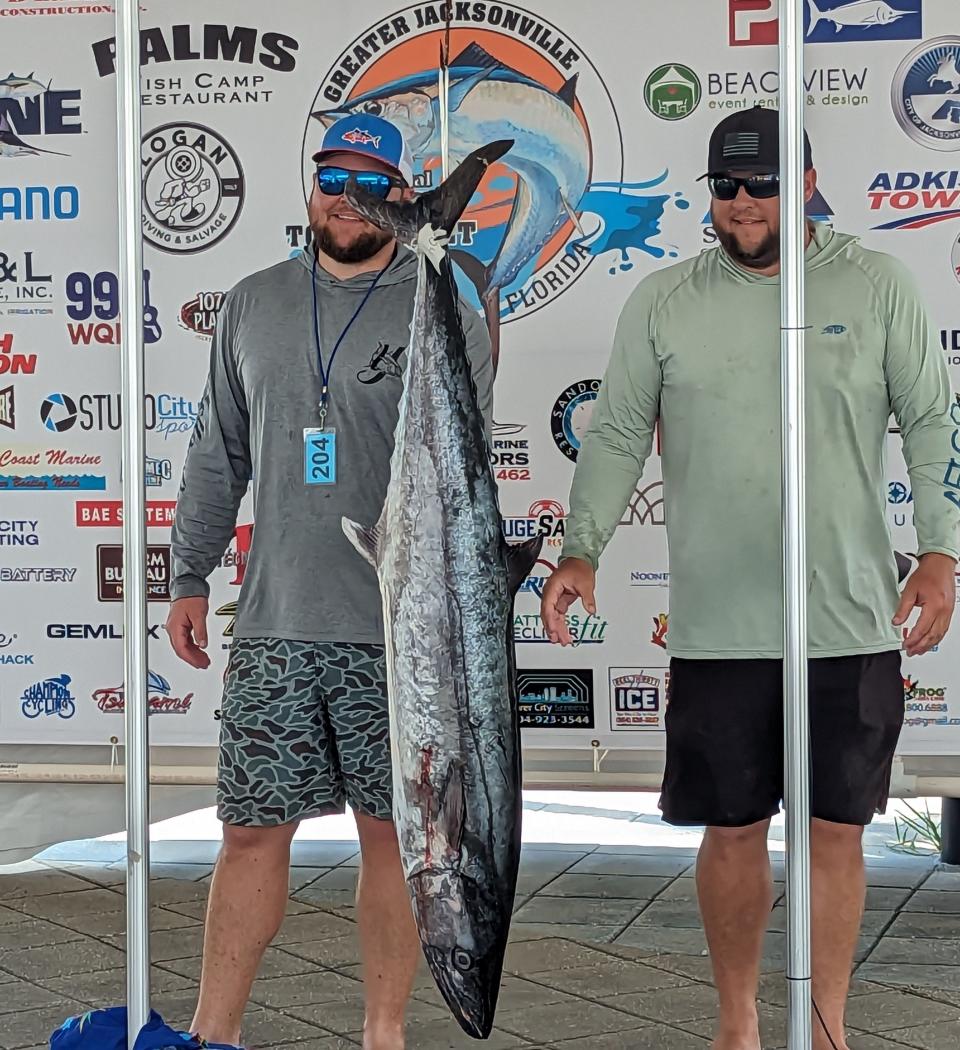 Lucas Crowley and Travis Crowley react to the record weight of their 57.75-pound kingfish at the Greater Jacksonville Kingfish Tournament on July 21, 2023. [Clayton Freeman/Florida Times-Union]