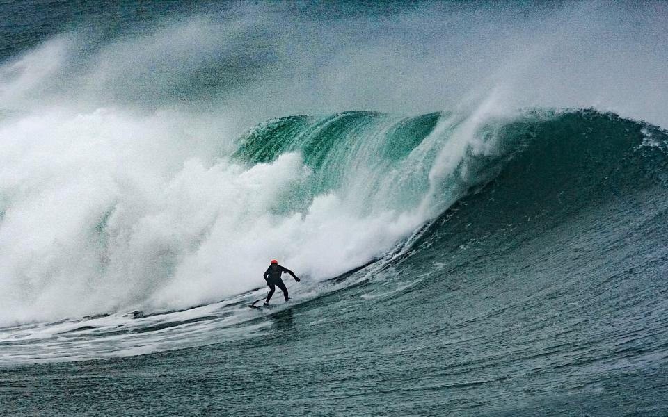 Jeff Scott surfing the Cribbar wave in Cornwall - Geoff Tydeman/SWNS