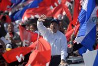 Nicaraguan President Daniel Ortega waves to supporters during the commemoration of the 39th Anniversary of the Sandinista Revolution