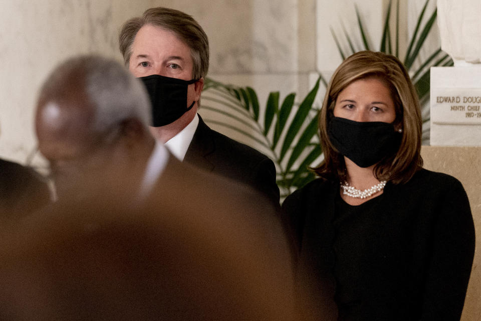 Justice Brett Kavanaugh and his wife Ashley stand during a private ceremony for Justice Ruth Bader Ginsburg at the Supreme Court in Washington, Wednesday, Sept. 23, 2020. Ginsburg, 87, died of cancer on Sept. 18. (AP Photo/Andrew Harnik, Pool)