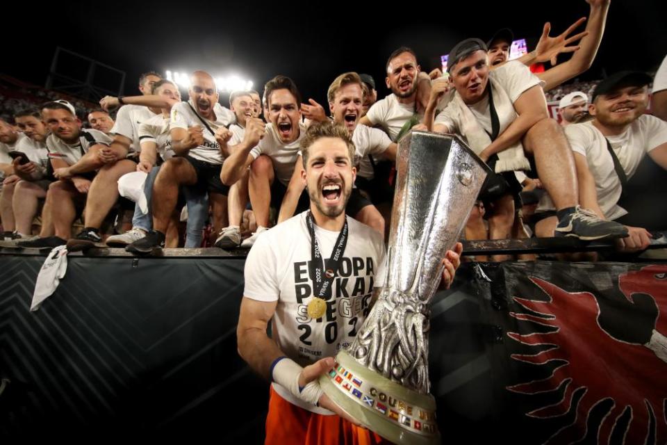 Kevin Trapp celebrates with the trophy in front of the Frankfurt fans, after his late saves earned Europa League glory.