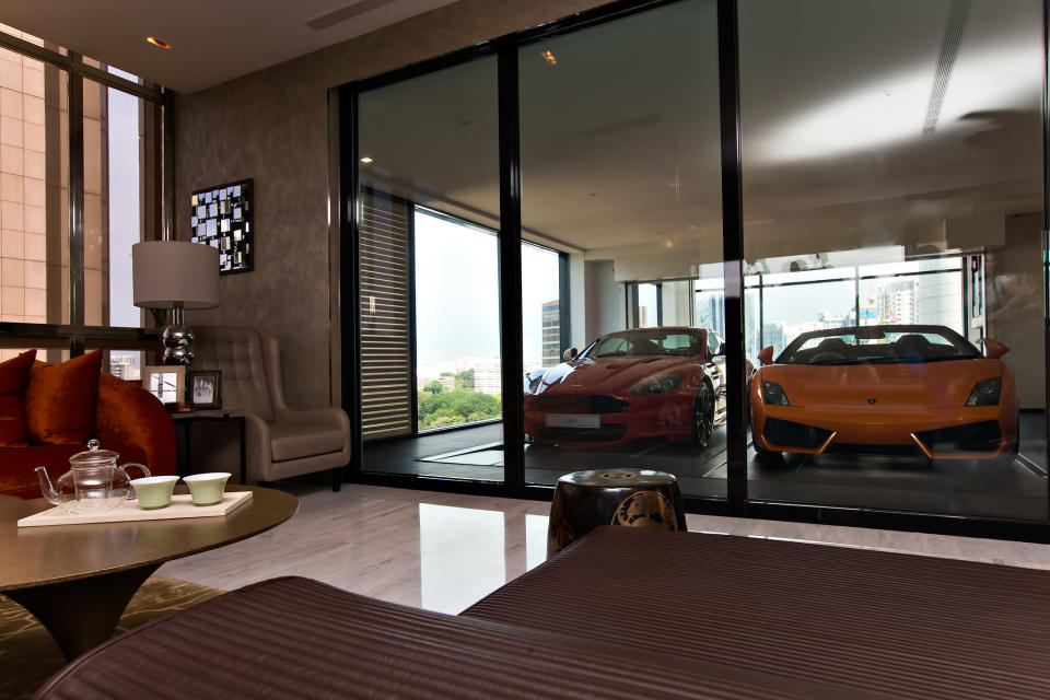 A Lamborghini Gallardo (R) arrives at an ensuite elevated garage on a 14th floor luxury apartment at the Hamilton Scotts luxury residence in Singapore August 23, 2012. Starting at S$9.5 million ($7.5 million) for the basic floor plan, each residence has two ensuite parking spaces, according to the property developer. (Yahoo! photo)