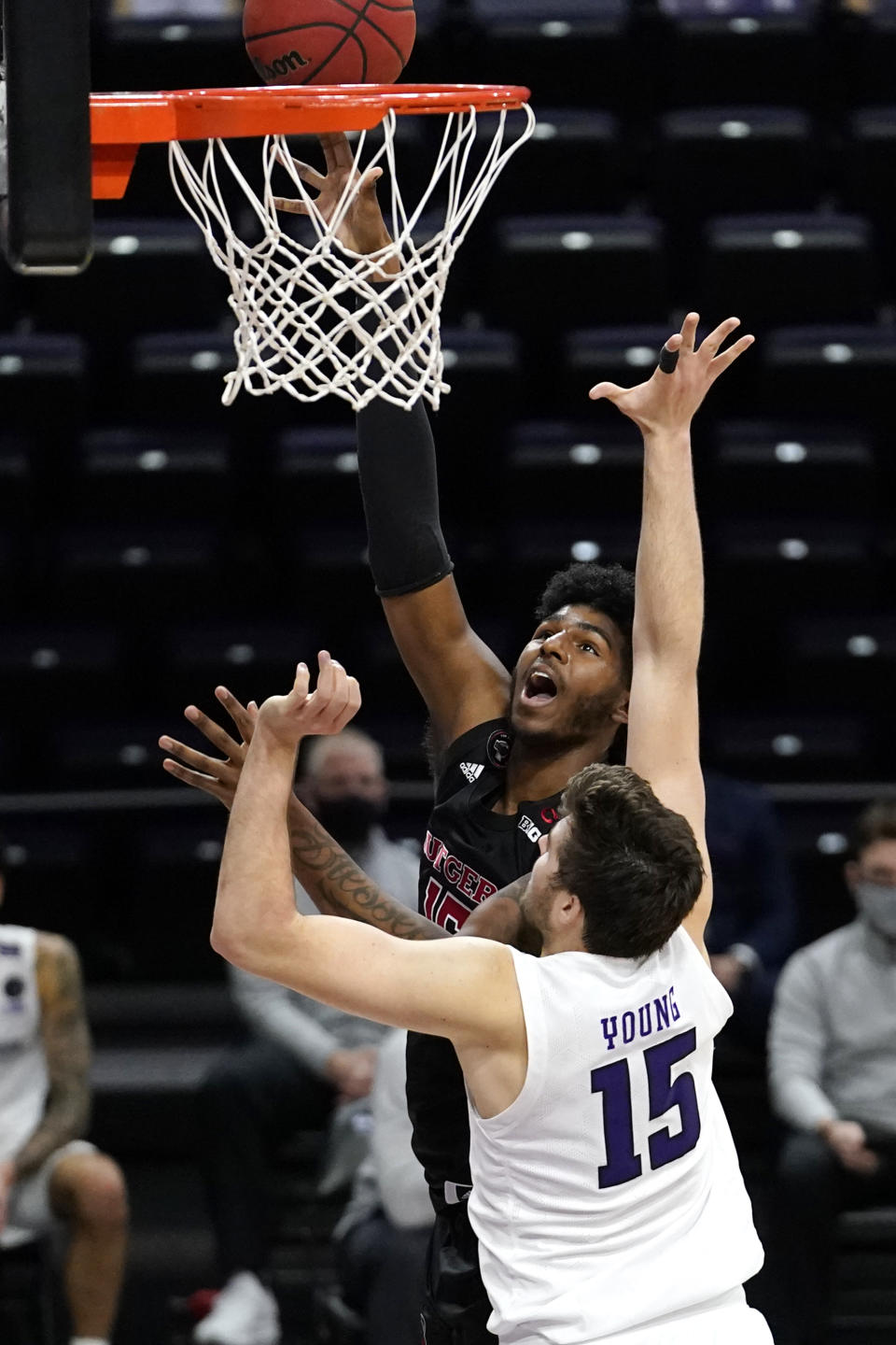 Rutgers center Myles Johnson, left, shoots against Northwestern center Ryan Young, right, during the first half of an NCAA college basketball game in Evanston, Ill., Sunday, Jan. 31, 2021. (AP Photo/Nam Y. Huh)