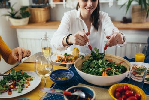 <span class="caption">Vegetarians had a 14% lower risk of developing all types of cancer compared to people who regularly eat meat.</span> <span class="attribution"><a class="link " href="https://www.shutterstock.com/image-photo/family-lunch-party-home-vegetarian-meal-1662594976" rel="nofollow noopener" target="_blank" data-ylk="slk:Dejan Dundjerski/ Shutterstock;elm:context_link;itc:0;sec:content-canvas">Dejan Dundjerski/ Shutterstock</a></span>