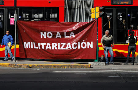 Activists hold a protest against a law that militarises crime fighting in the country outside the Senate in Mexico City, Mexico December 14, 2017. Baner reads, "No to the Militarisation in the Country". Picture taken December 14, 2017. REUTERS/Carlos Jasso