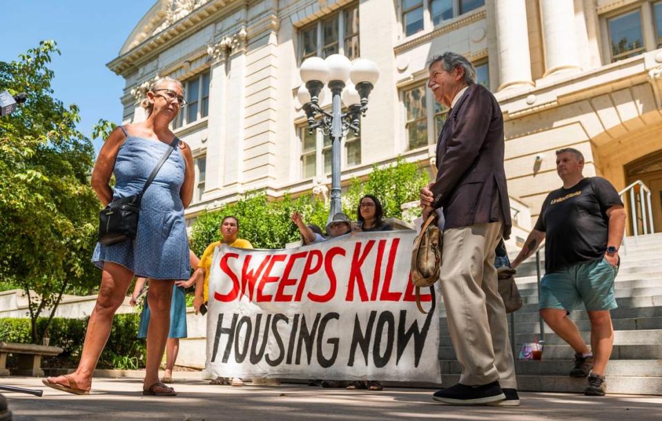 Tamie Dramer, with Organize Sacramento, and Sacramento Attorney Mark Merin, protest a press conference organized by the lead proponent of the homeless ballot measure, a coalition of Sacramento business leaders.