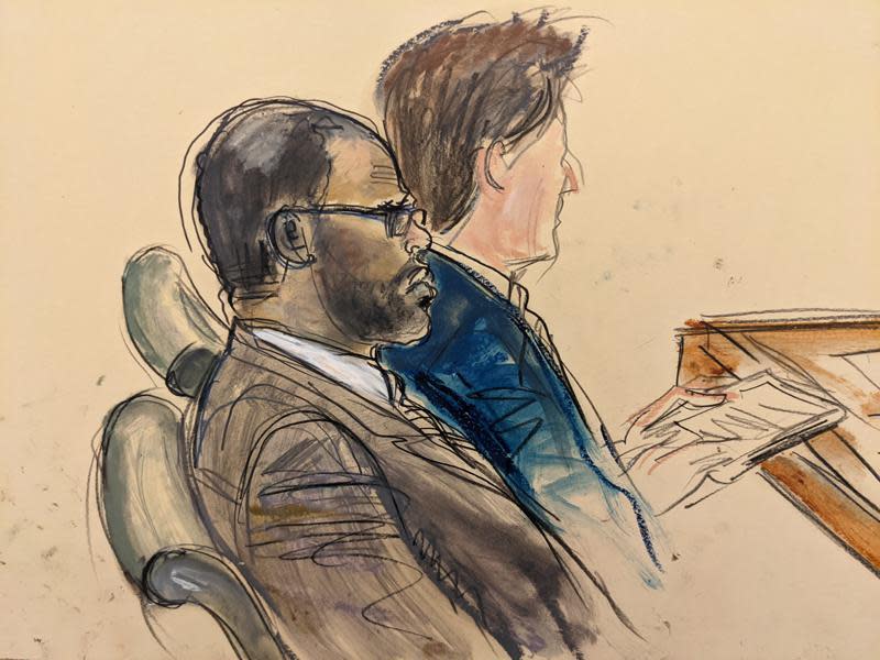 In this courtroom artist's sketch made from a video screen monitor of a Brooklyn courtroom, defendant R. Kelly, left, listens during the opening day of his racketeering trial on August 18, 2021, in New York. / Credit: Elizabeth Williams/AP