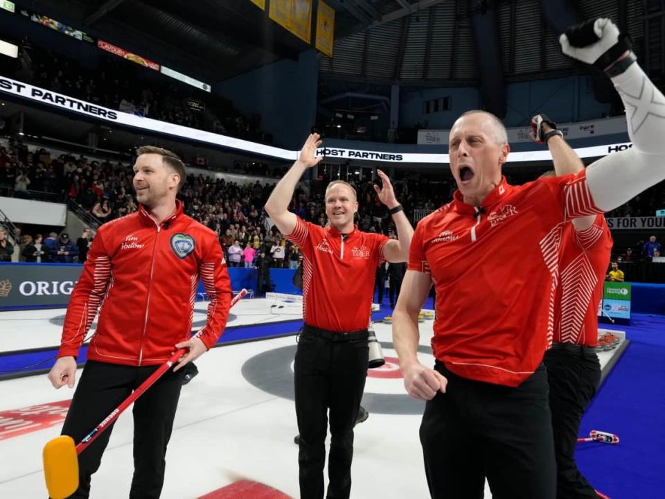 Team Canada skip Brad Gushue, Mark Nichols and E.J. Harnden, left to right, celebrate defeating Team Manitoba in the finals of the 2023 Tim Hortons Brier in London, Ont., on March 12. (The Canadian Press - image credit)