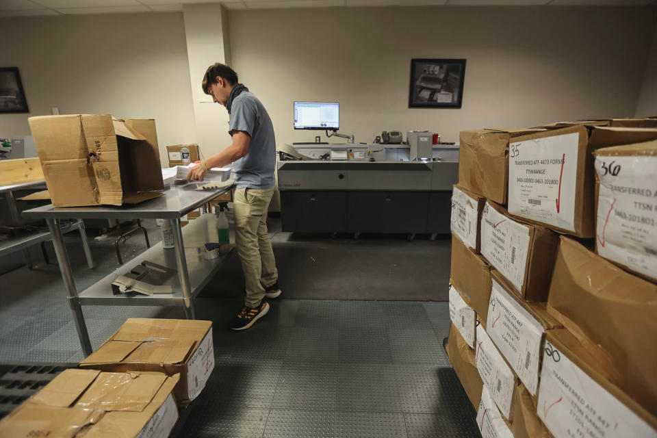 An ATF worker prepares gun sale documents before they are scanned. (Peter Kavanagh / NBC News)